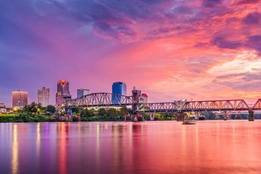 Arkansas city skyline and river at dusk