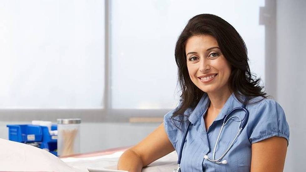 Happy nurse doctor reading over patient notes